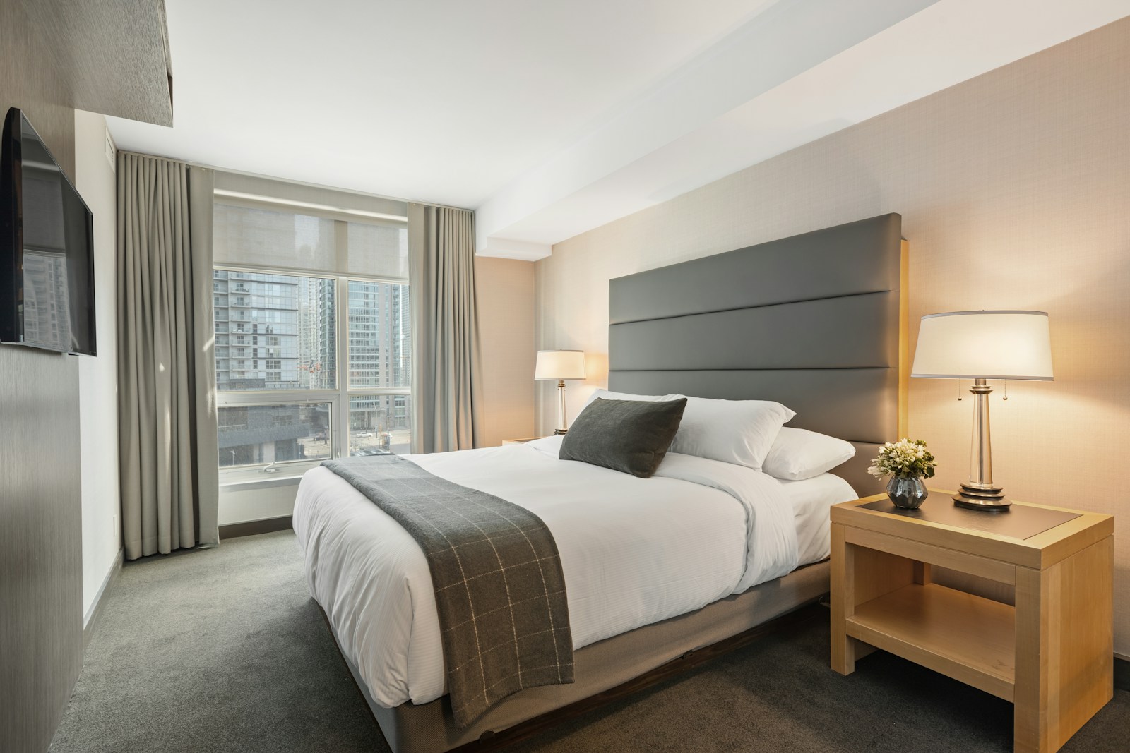 Crisp white bed linen in a carefully presented guest bedroom